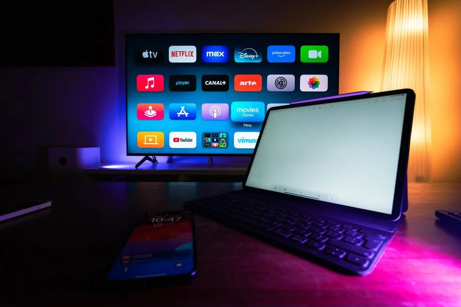 who-we-are Overhead view of a minimalist arrangement with a tablet and smartphones placed on a white surface.
