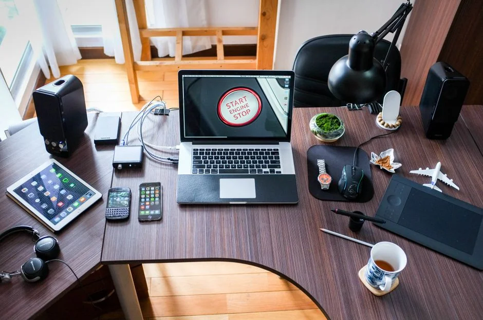 team-01 A clean and modern workspace featuring a laptop, tablet, smartphone, and monitor. Ideal for remote work and tech setups.